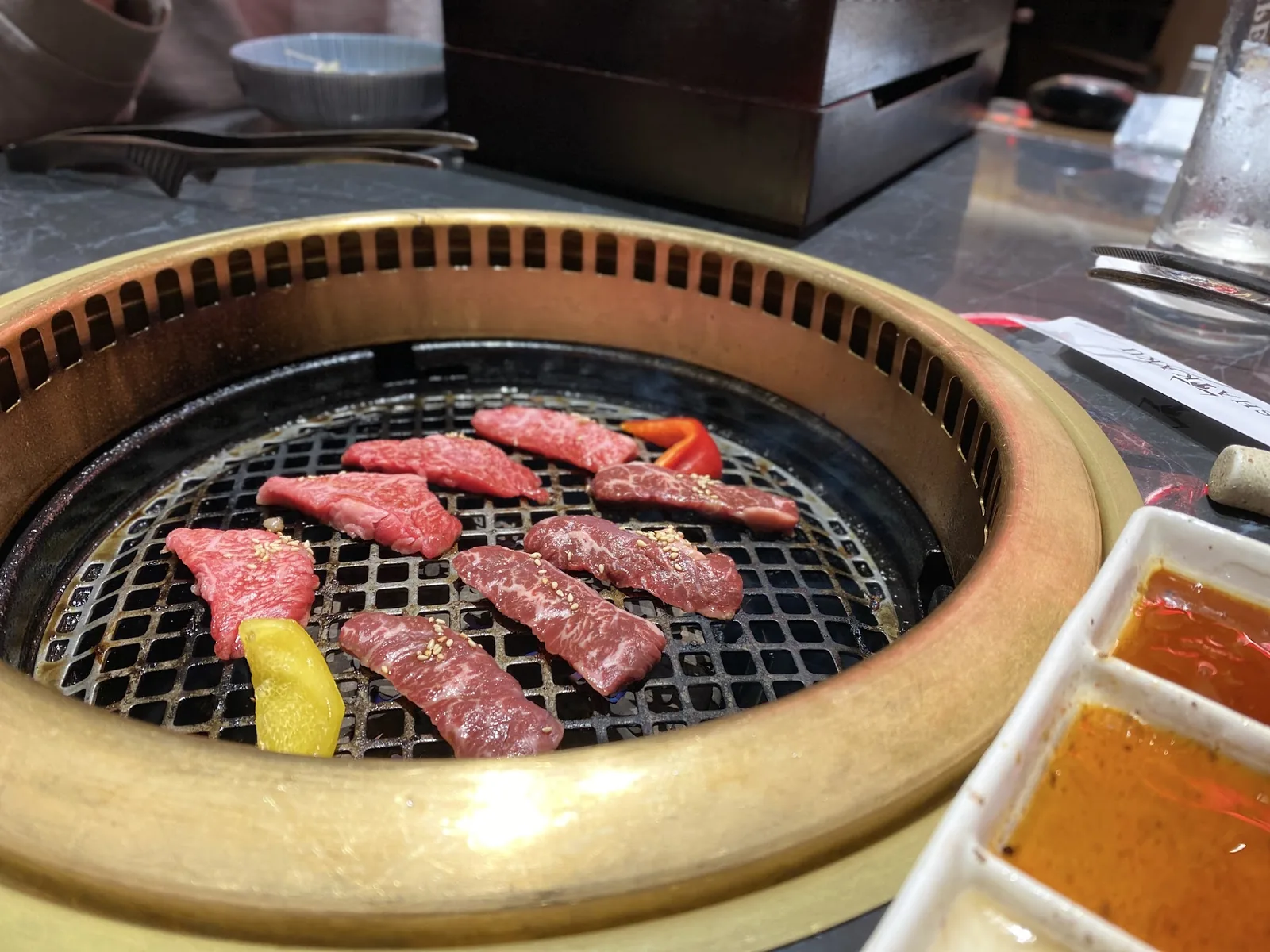Sliced meat on a tabletop grill, used as a general image for wild boar cooking.